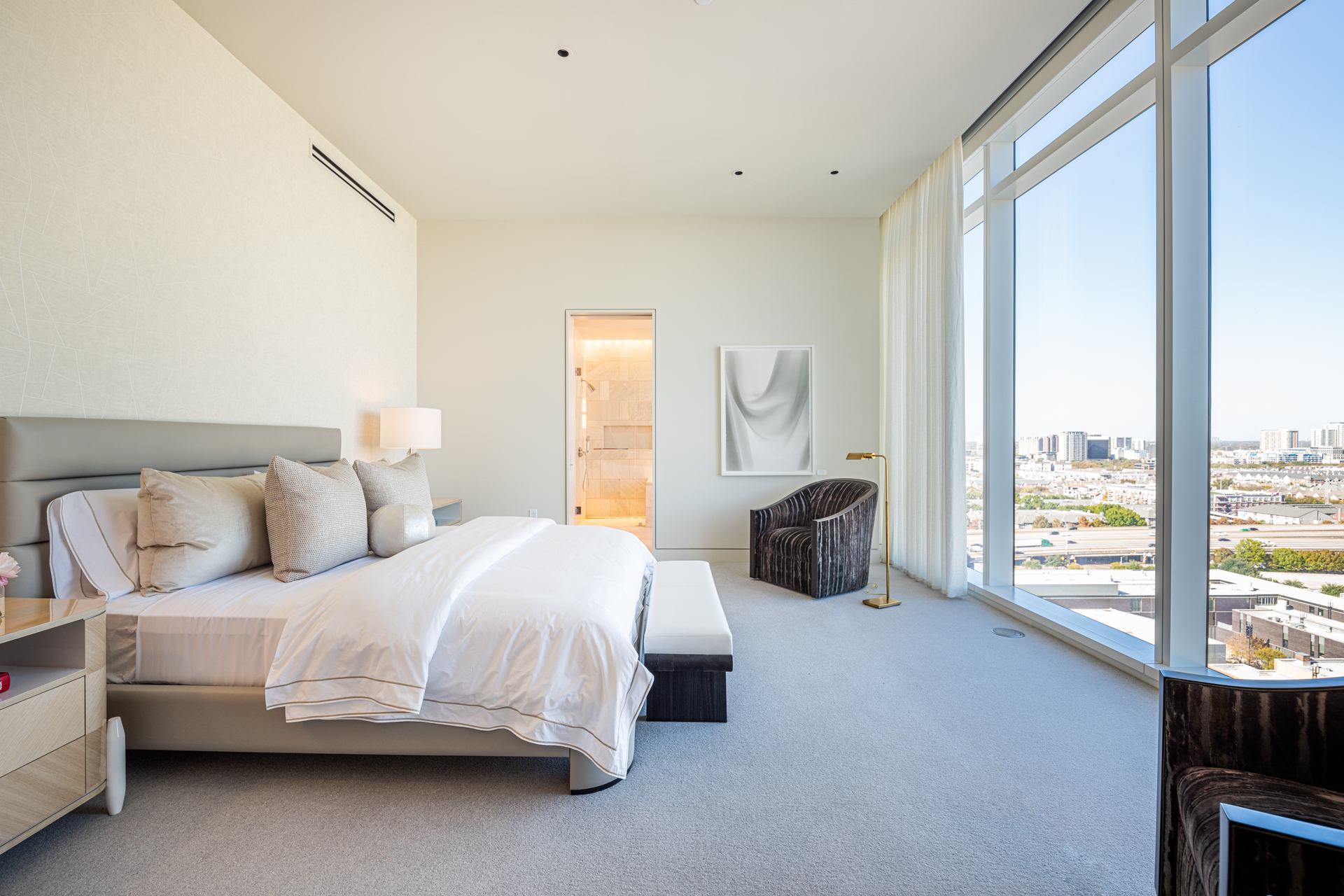 Modern bedroom with views of the city.